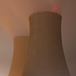 a nuclear power plant at night with a foggy sky