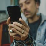man holding black Android smartphone