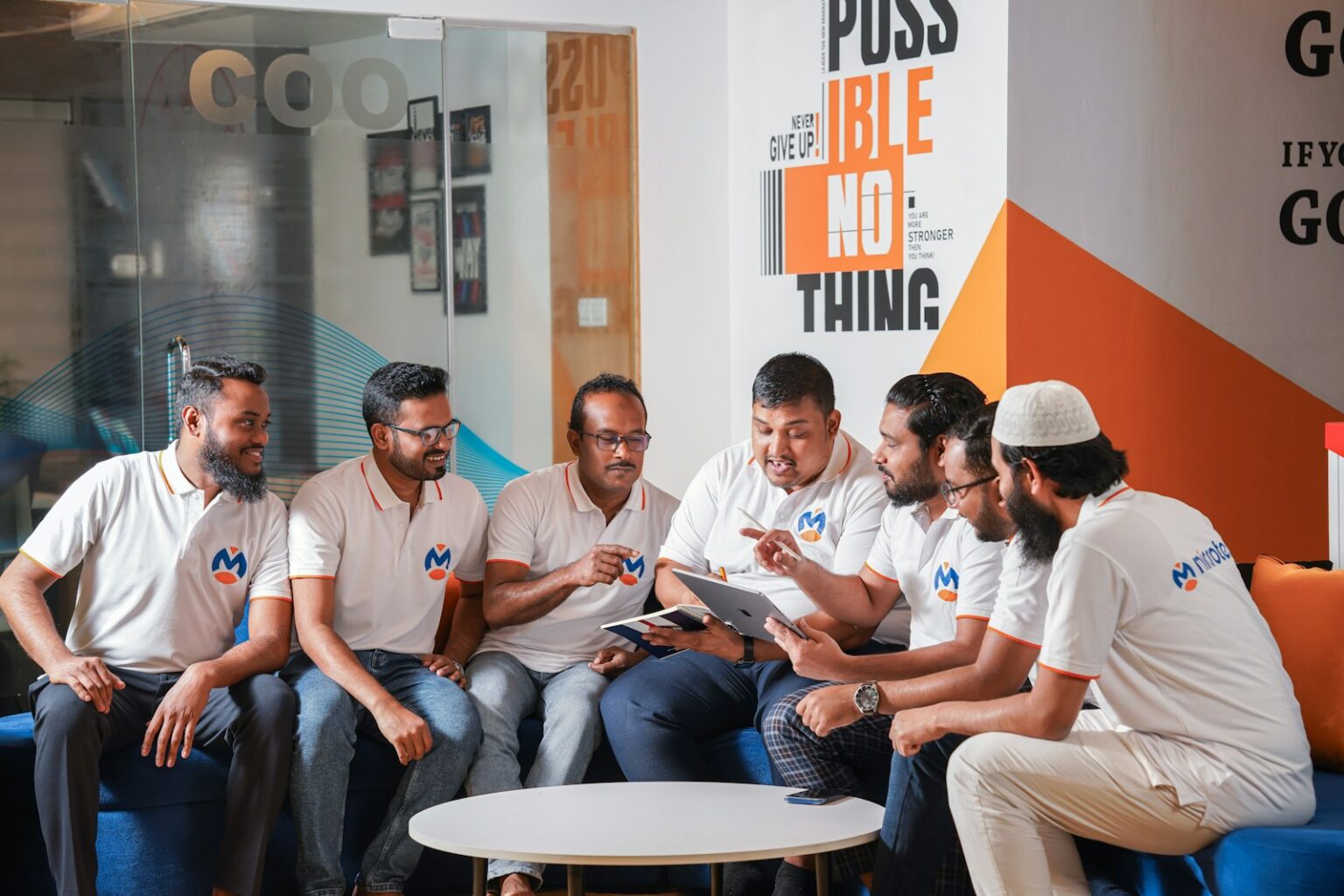 A group of men sitting around each other