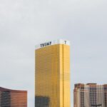 gold-colored Trump high-rise building between of two gold-colored buildings