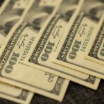 a pile of twenty dollar bills laying on top of each other