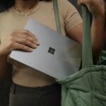 Female putting her Surface laptop in her bag