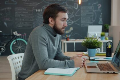Man working on laptop in modern office space